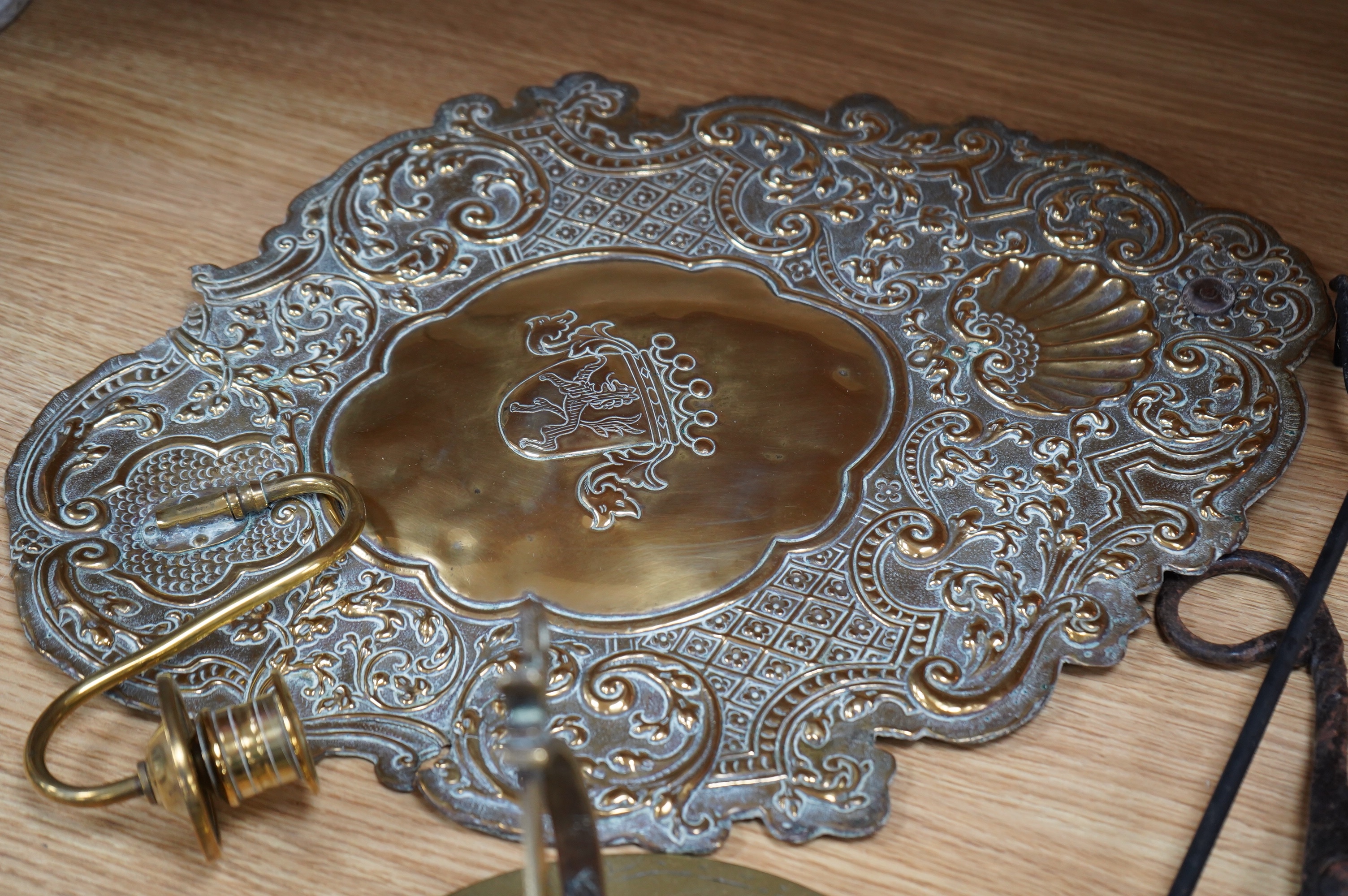 A pair of brass repousse wall sconces, a copper two handle mug, a small brass sun dial, a pair of tongs and a roasting trivet. Condition - poor to fair